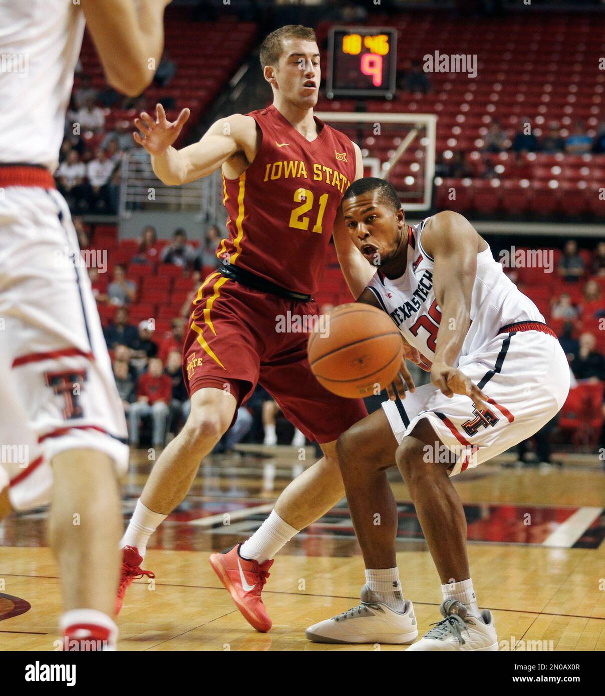 Texas Tech guard Toddrick Gotcher passes to a teammate defended by Iowa