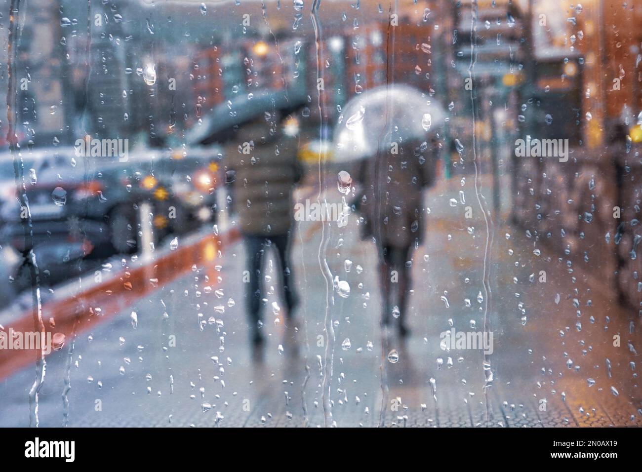 people with an umbrella in rainy season in wintertime in bilbao city, Basque country, Spain Stock Photo