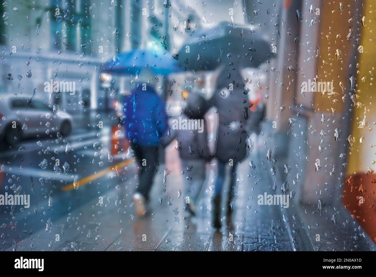 people with an umbrella in rainy season in wintertime in bilbao city, Basque country, Spain Stock Photo