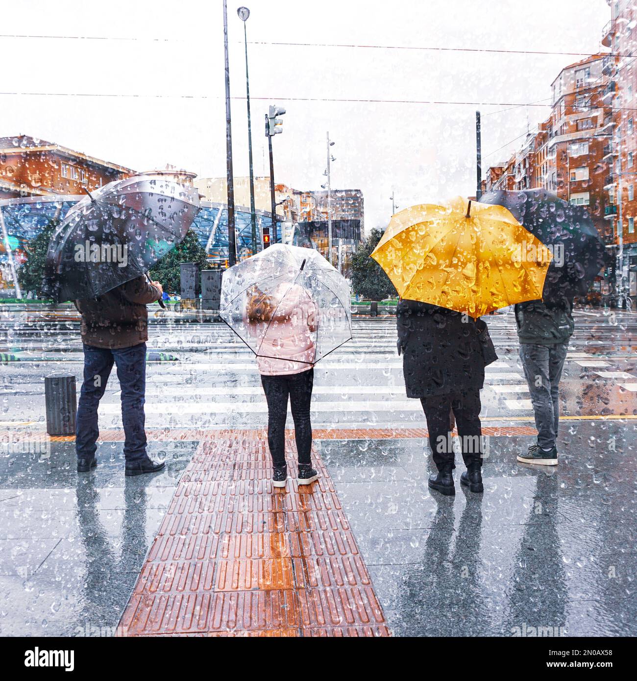 people with an umbrella in rainy season in wintertime in bilbao city, Basque country, Spain Stock Photo