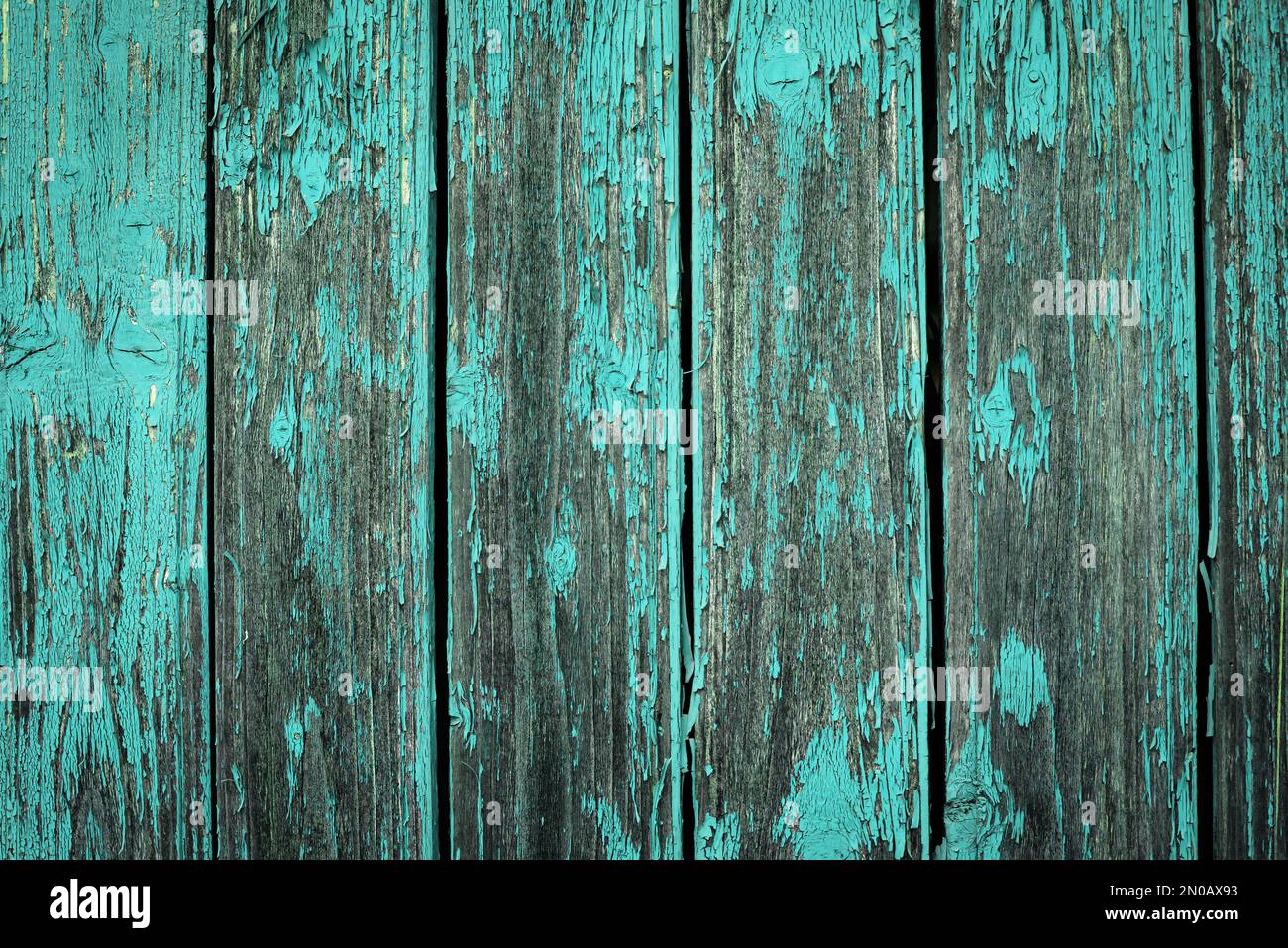 Old natural weathered wooden planks with cracked blue paint background Stock Photo