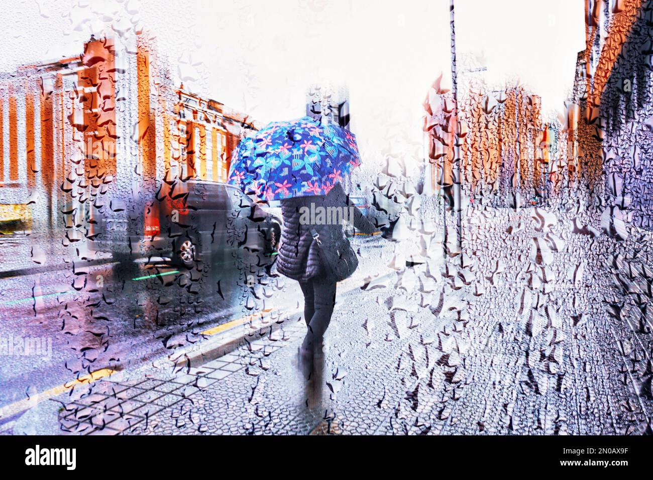 people with an umbrella in rainy season in wintertime in bilbao city, Basque country, Spain Stock Photo