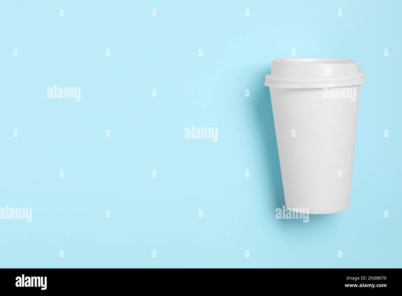 Takeaway paper coffee cup with on light blue background, top view ...