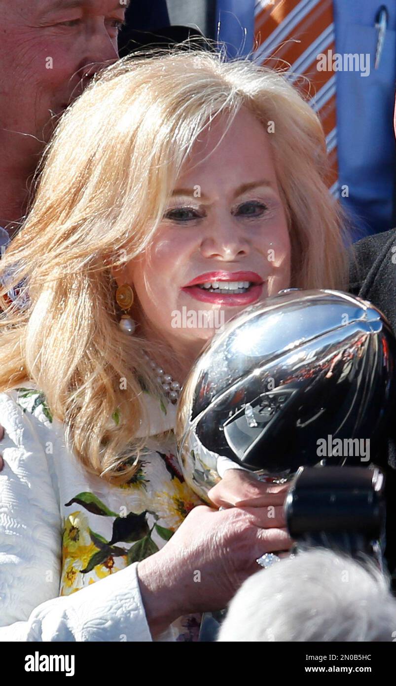 Annabelle Bowlen, wife of Denver Broncos owner Pat Bowlen, is reflected by  light shining off the Lombardi Trophy at a rally following a parade through  downtown Tuesday, Feb. 9, 2016 in Denver.
