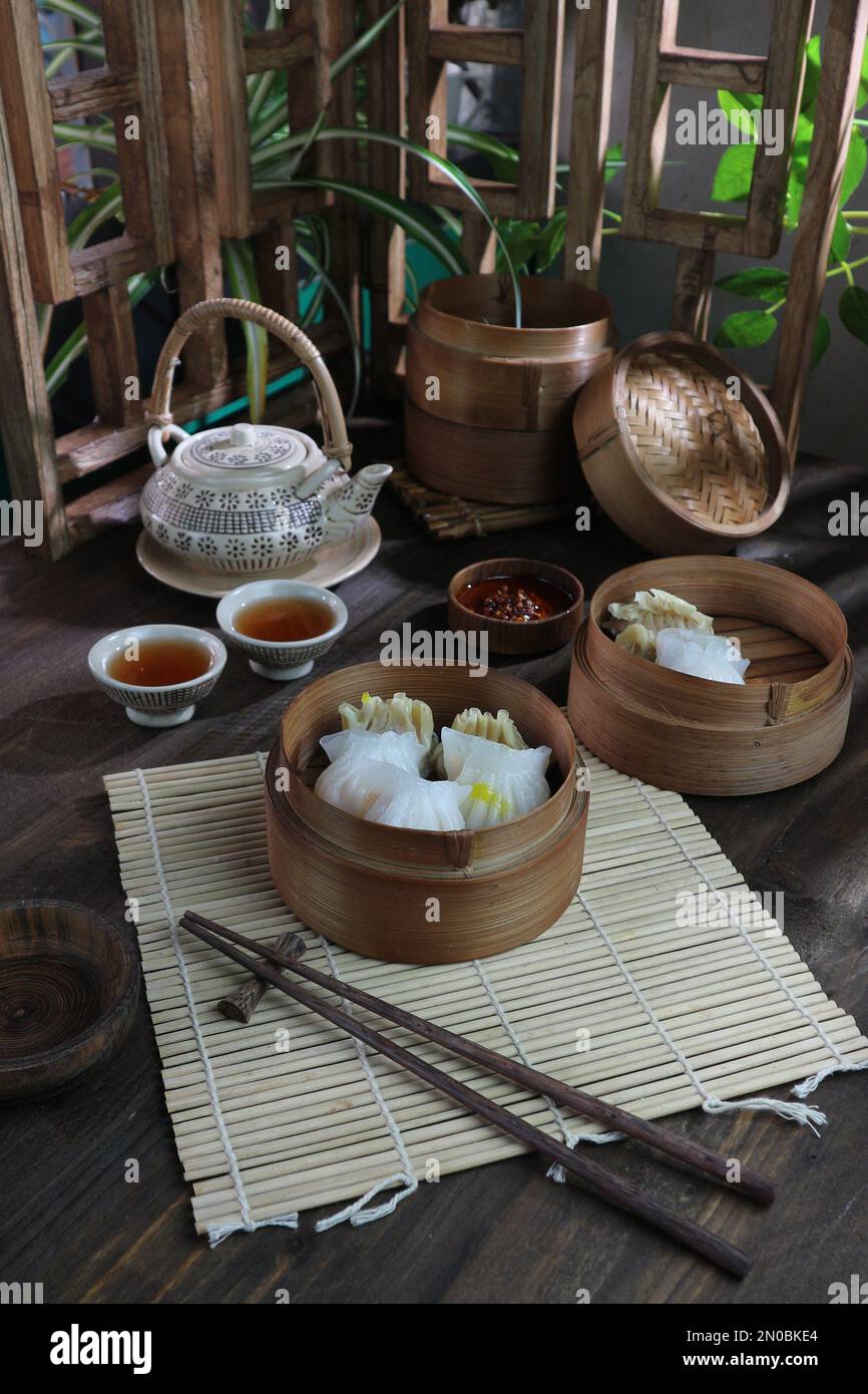 serving of dimsum with tea on a wooden table Stock Photo