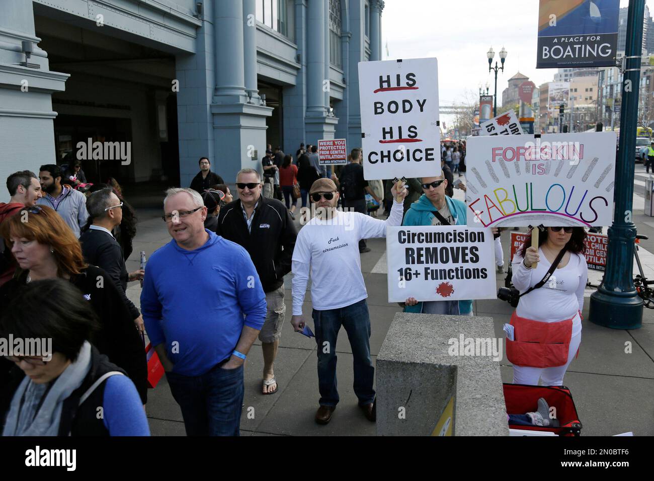 A group of people protest against circumcision on the Embarcadero ...