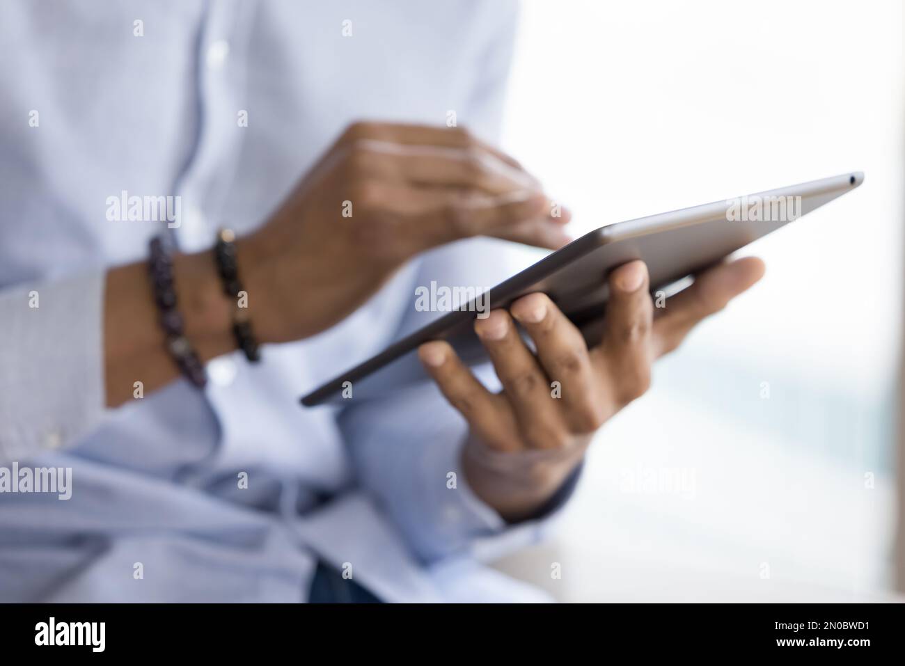 African gadget user man holding tablet computer, touching screen Stock Photo