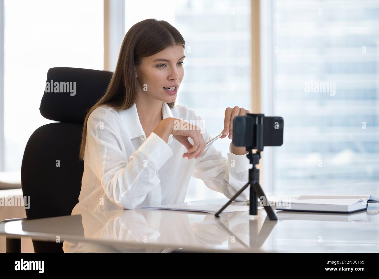Pretty young influencer, business blogger woman broadcasting online Stock Photo