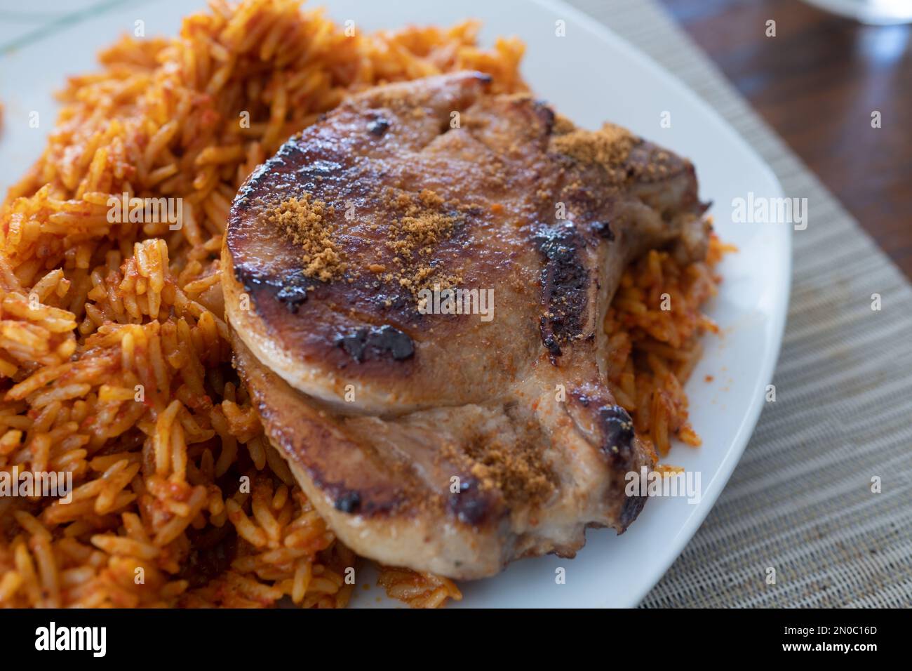 nigerian Jollof Rice served with Pork Chops Stock Photo Alamy