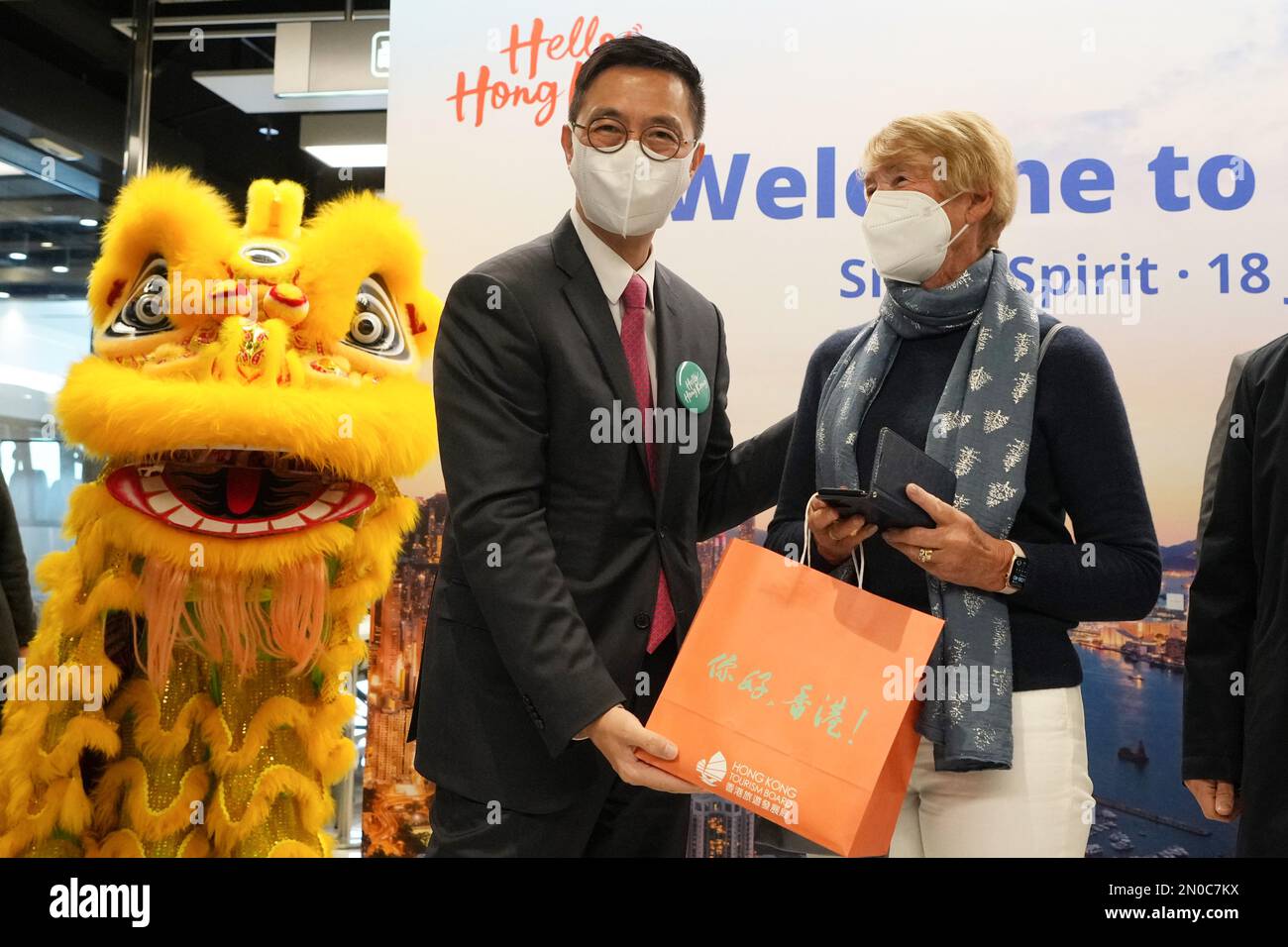 Passengers of SilverSea Cruises' Silver Spirit cruise ship are greeted by Secretary for Culture, Sports and Tourism Kevin Yeung Yun-hung with souvenirs as the cruise liner docks at Tsim Sha Tsui Ocean Terminal.  It is the first cruise ship which visits the city in 3 years since the start of the coronavirus pandemic. 18JAN23   SCMP / Elson Li Stock Photo