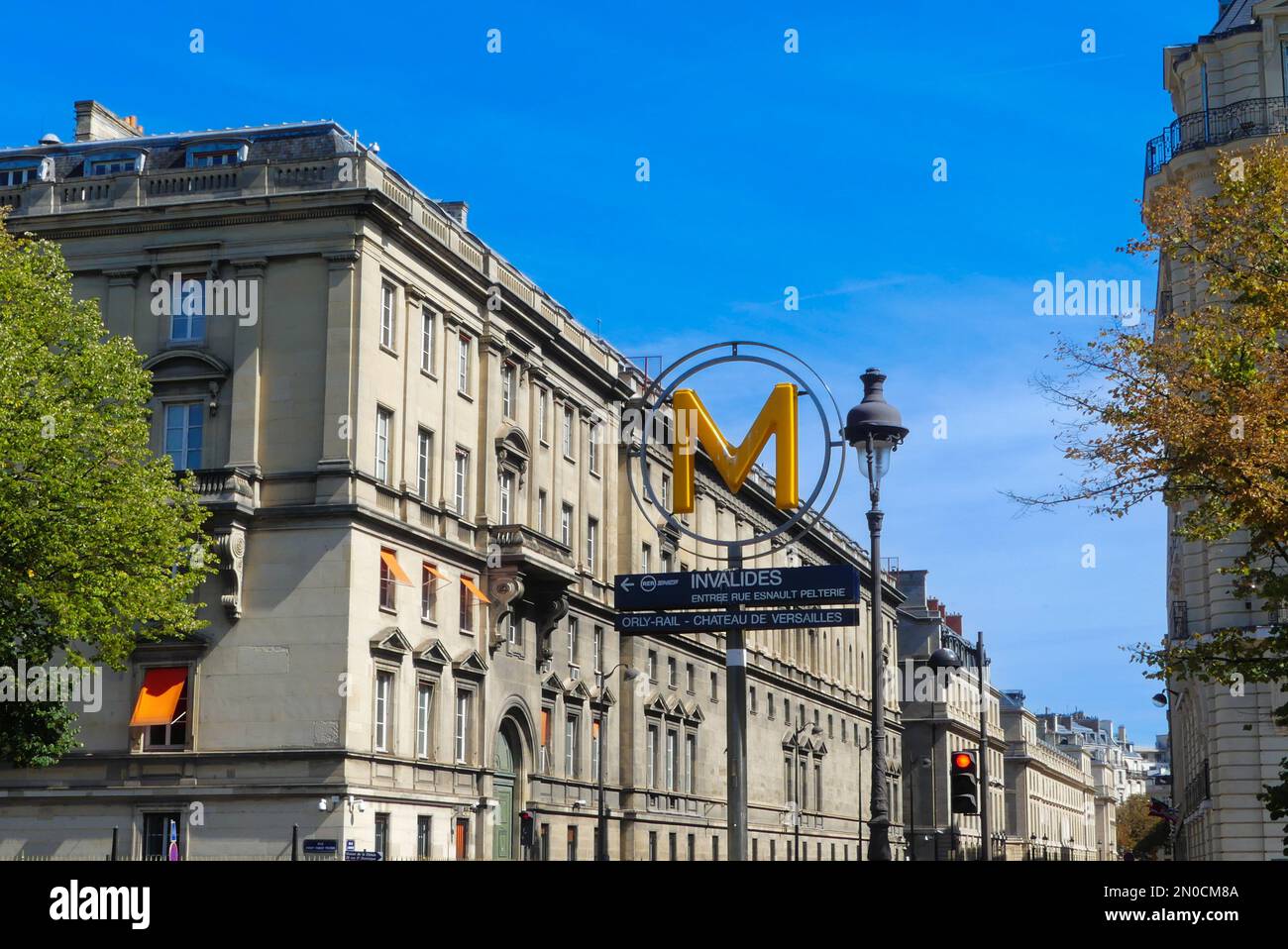 Paris, France. April 09. 2022. Logo with the RATP panel indicating the entrance to Invalides public transport. Haussmann building. Stock Photo