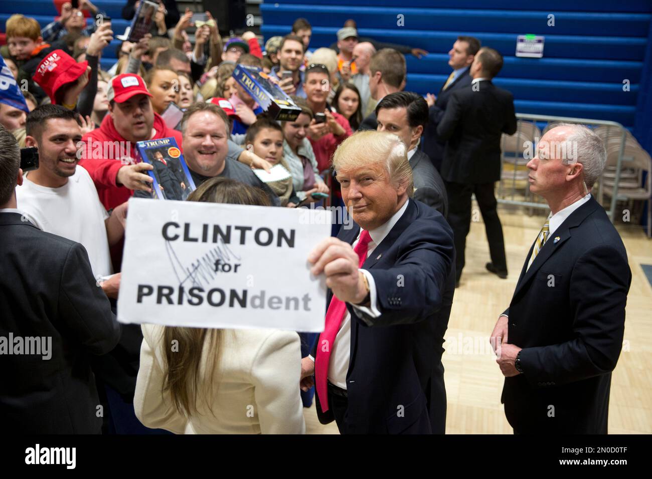 Republican presidential candidate Donald Trump pauses with a sign with ...