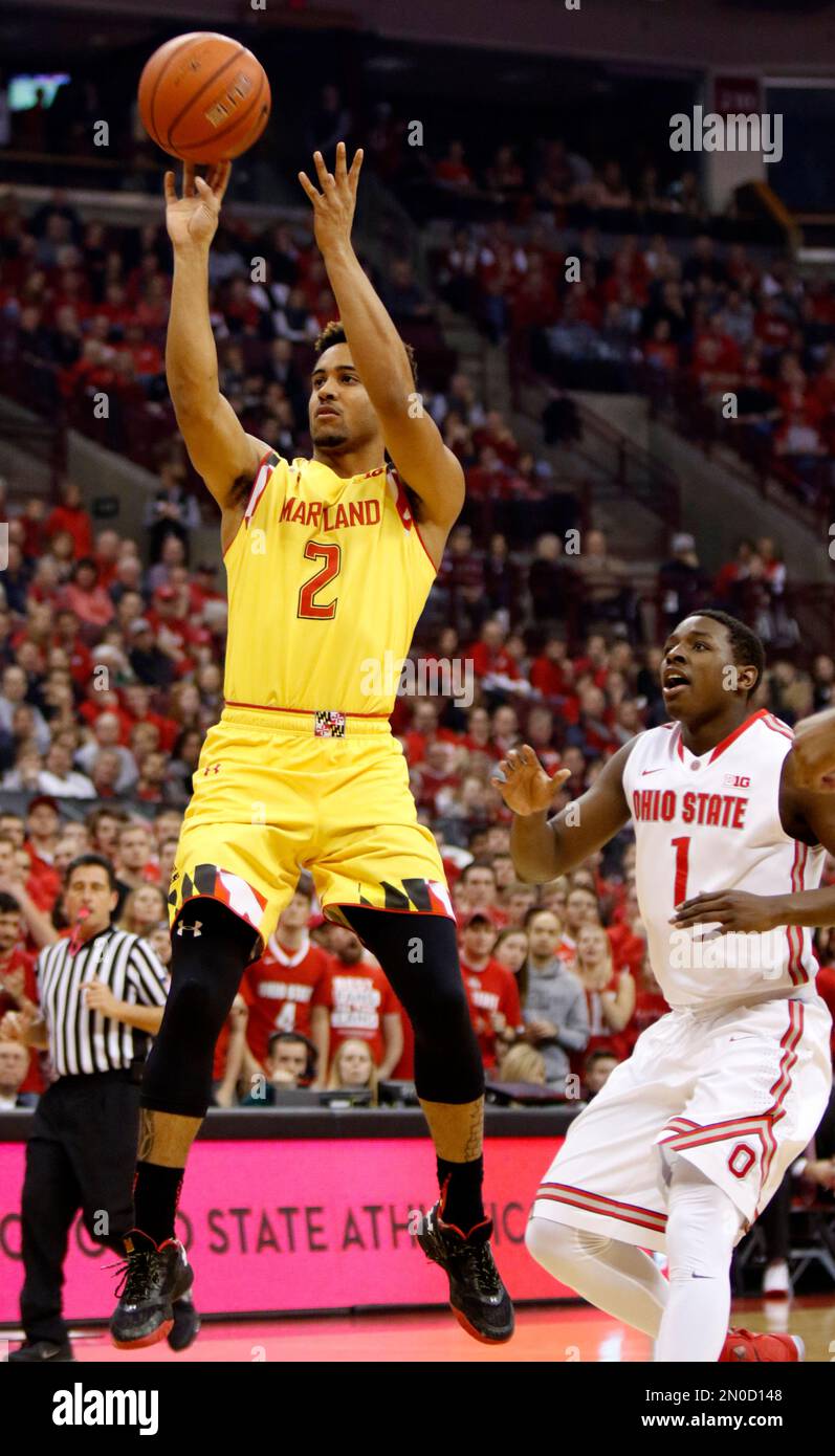 Maryland's Melo Trimble, left, goes up to shoot against Ohio State's Jae'Sean Tate during the