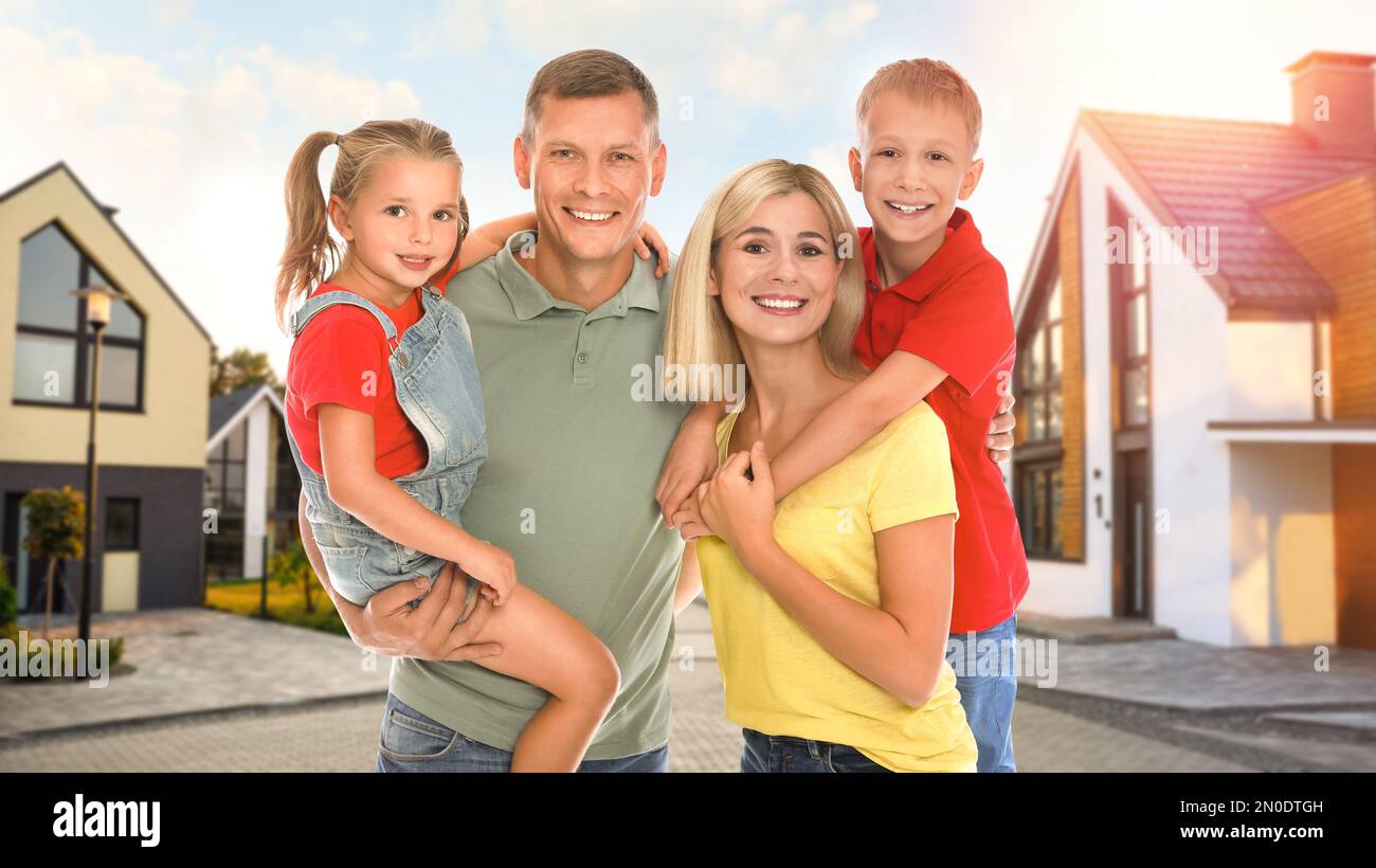 Happy family standing in front of their house on sunny day Stock Photo ...