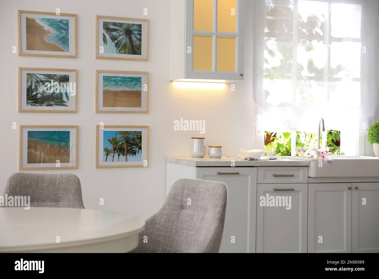 Stylish kitchen interior with beautiful artworks on wall Stock Photo ...