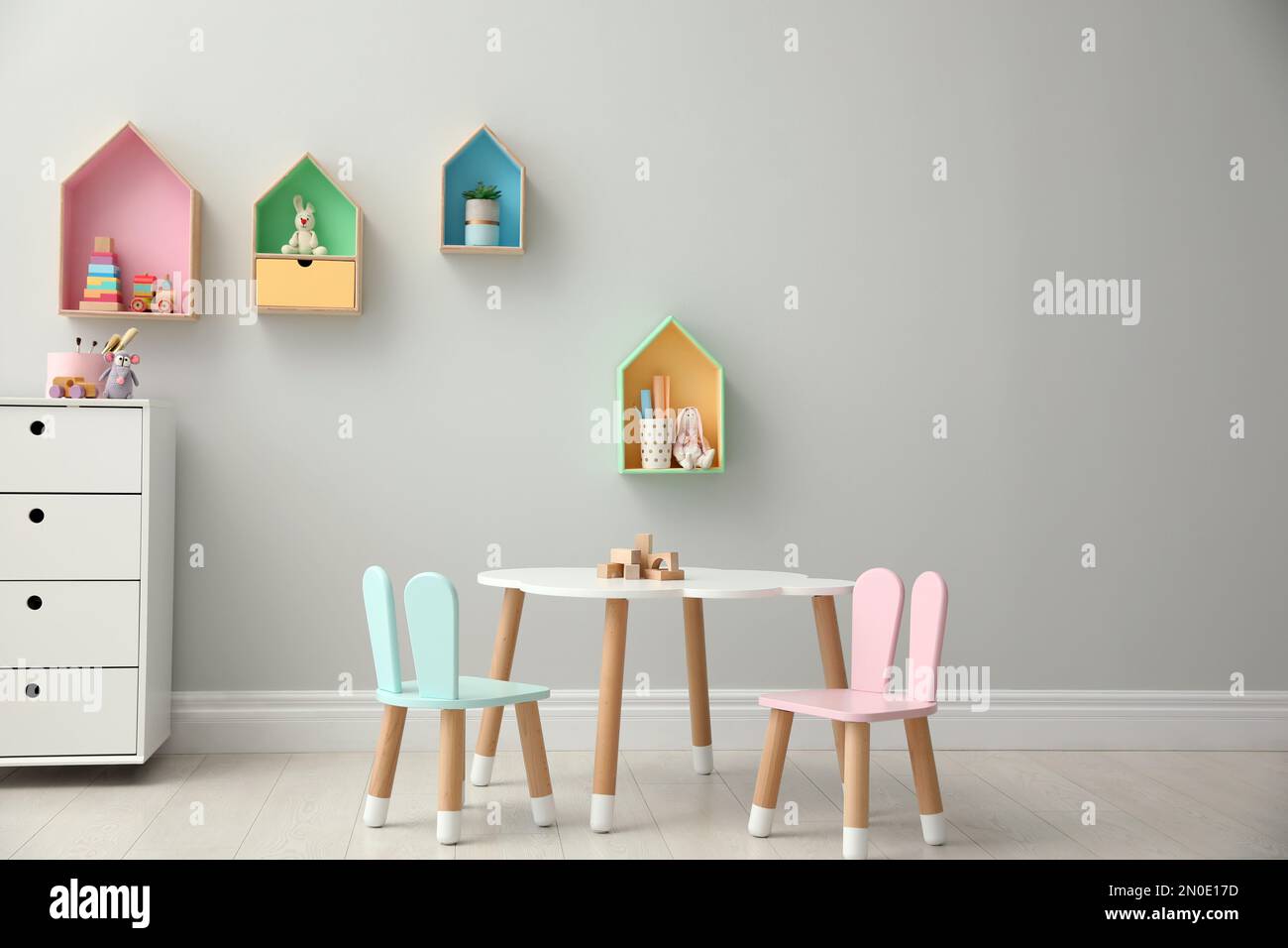 House shaped shelves and little table with chairs in children's room ...
