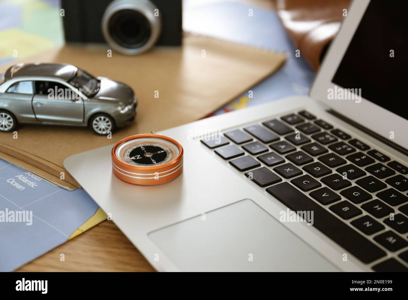 Composition with laptop and different items on world map. Trip planning Stock Photo