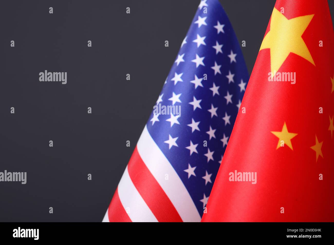 Closeup view of USA and China flags on dark background, space for text. International relations Stock Photo