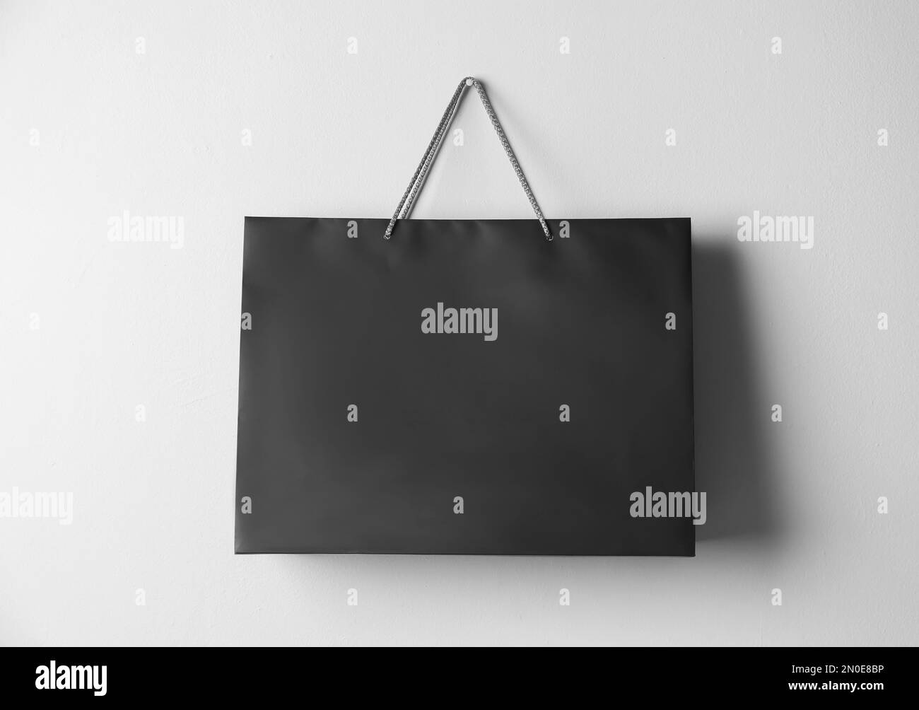 Paper shopping bag hanging on white wall Stock Photo Alamy