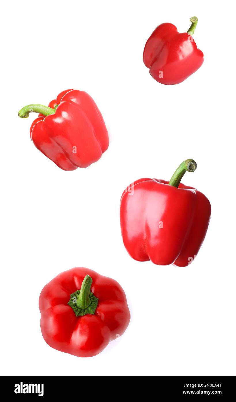 Red bell peppers falling on white background Stock Photo Alamy