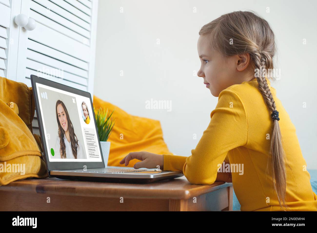 Cute child school girl studying online on laptop at home Stock Photo ...