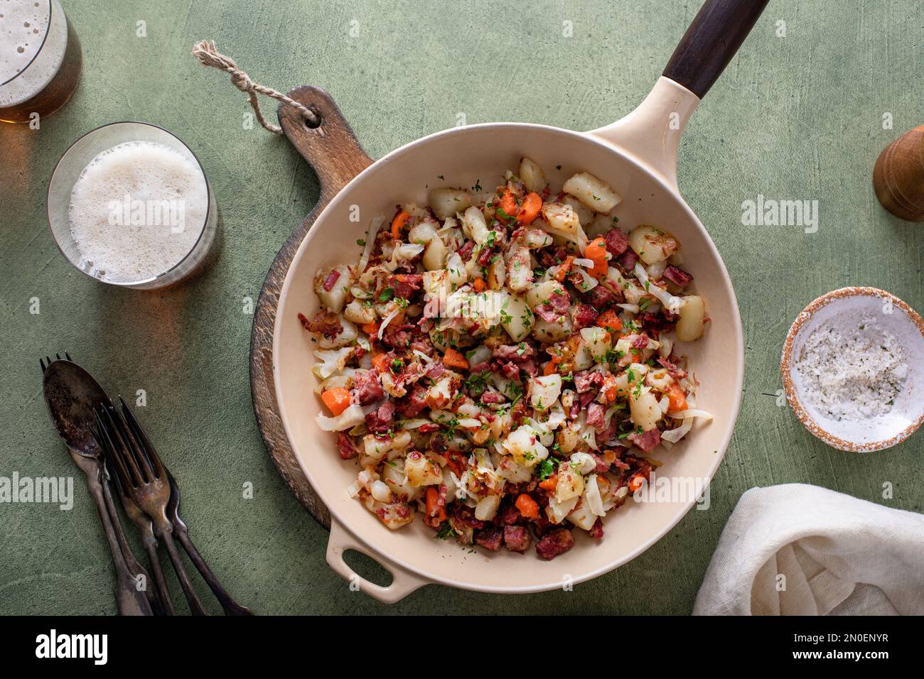 Corned beef hash with potatoes, cabbage and carrot in a cast iron pan