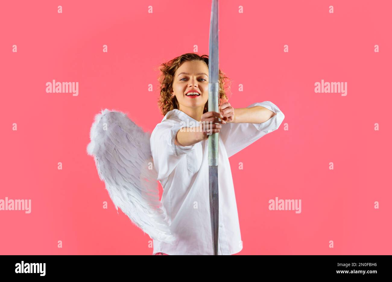 Arrow of love. Female angel with bow and arrows. Valentines Day concept. Cupid shooting love arrow. Stock Photo