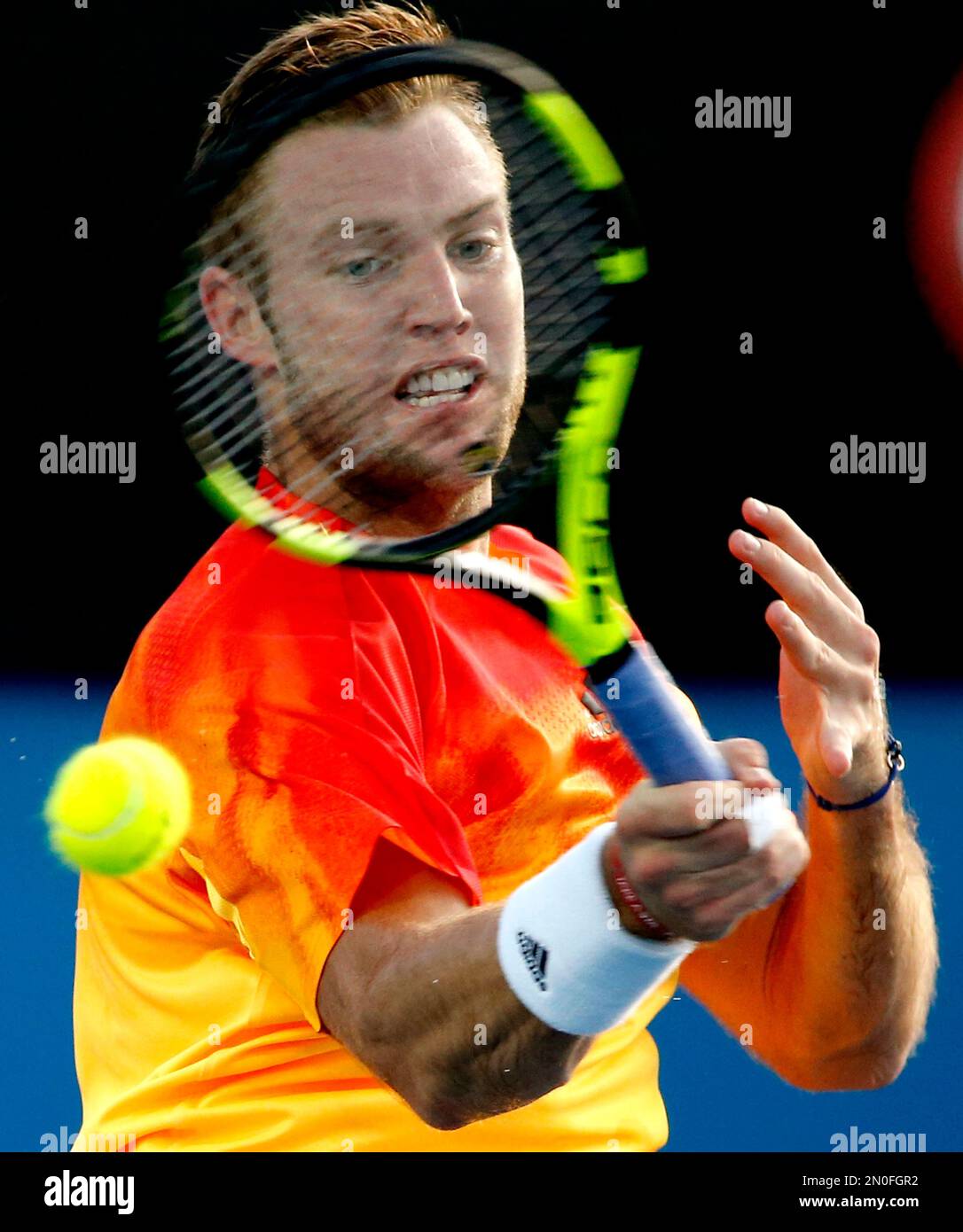 Jack Sock of the United States hits a forehand return to Lukas Rosol of