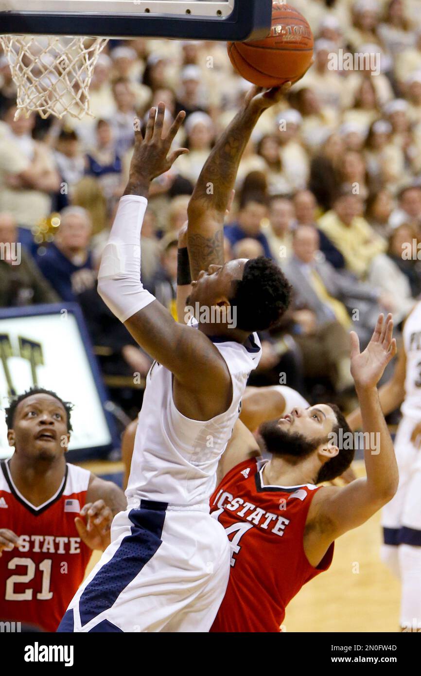 Pittsburgh's Jamel Artis shoots as North Carolina State's Caleb Martin ...