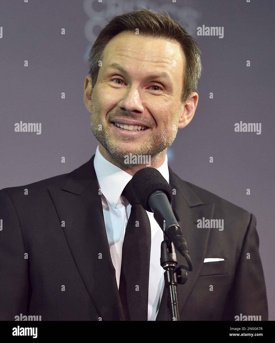 Christian Slater poses in the press room with the award for best ...