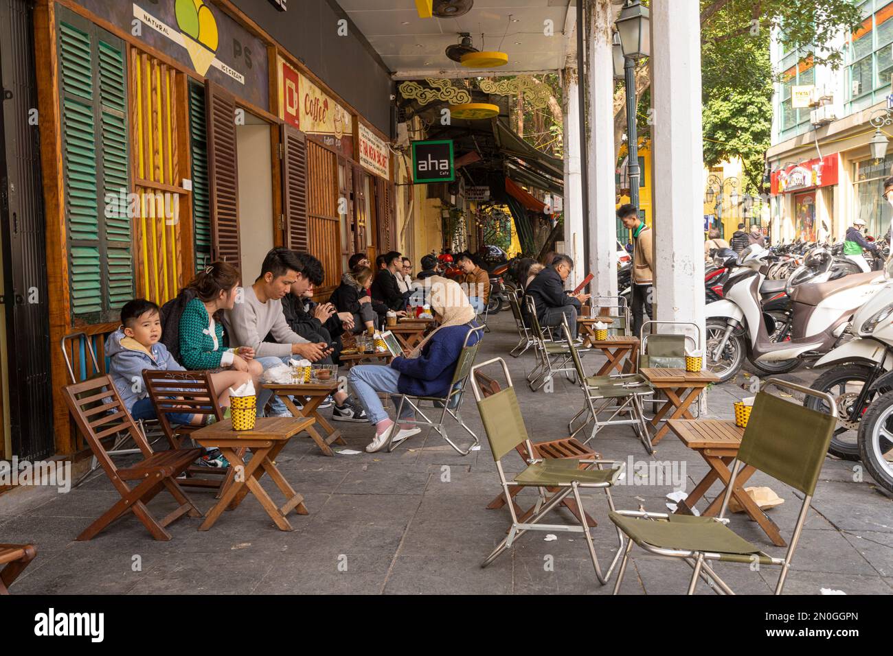 Hanoi, Vietnam, January 2023. people sitting at the outdoor cafe on the street in the city center Stock Photo