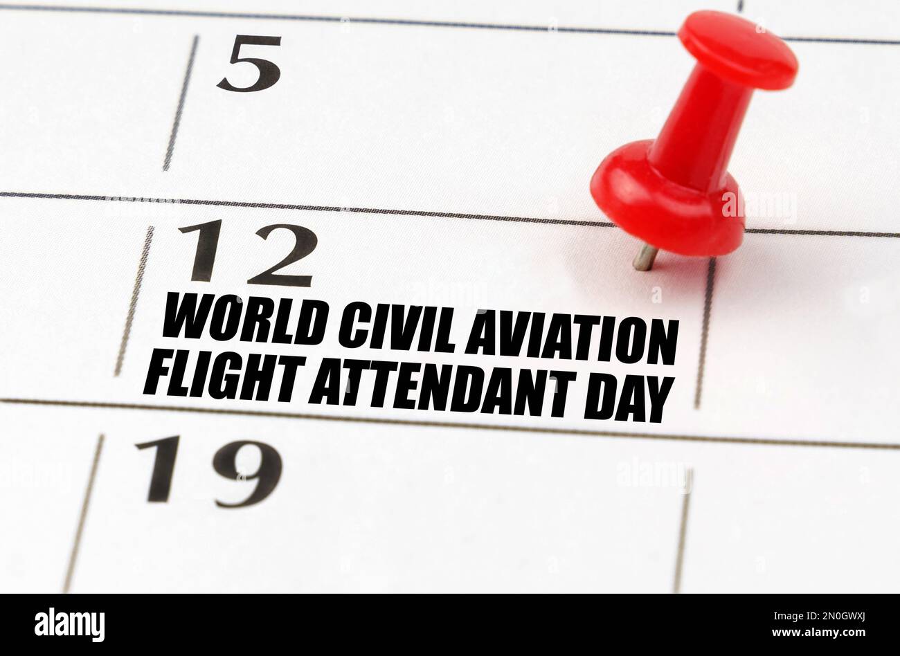 International holidays. On the calendar grid, the date and name of the holiday - July 12 - World Civil Aviation Flight Attendant Day Stock Photo