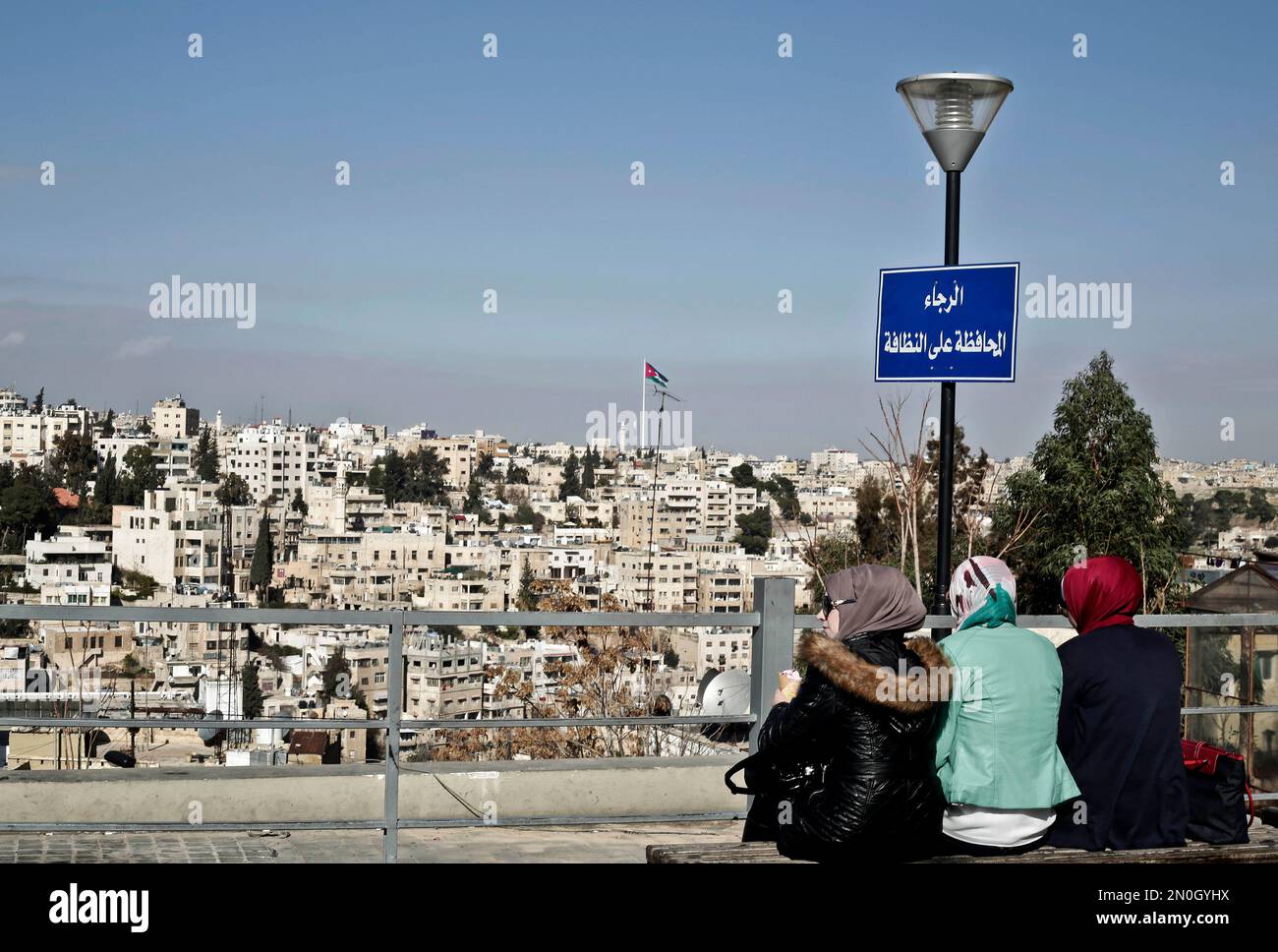 Syrian women eat ice cream as they enjoy the view in Amman, Jordan