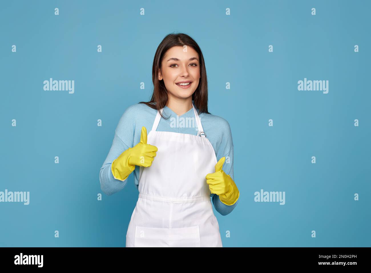 woman in rubber gloves and cleaner apron showing ok sign Stock Photo ...