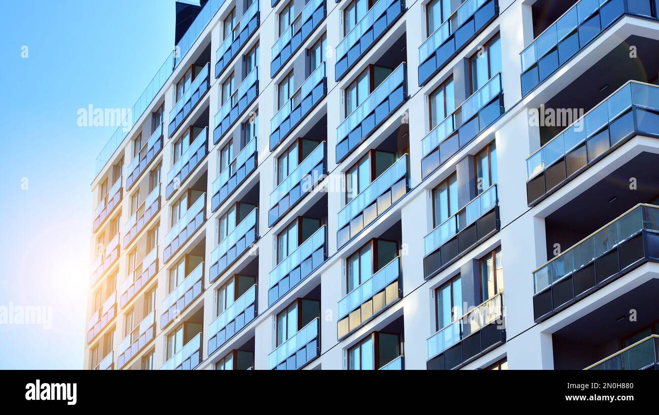 New apartment building with glass balconies. Modern architecture houses by the sea. Large glazing on the facade of the building. Stock Photo