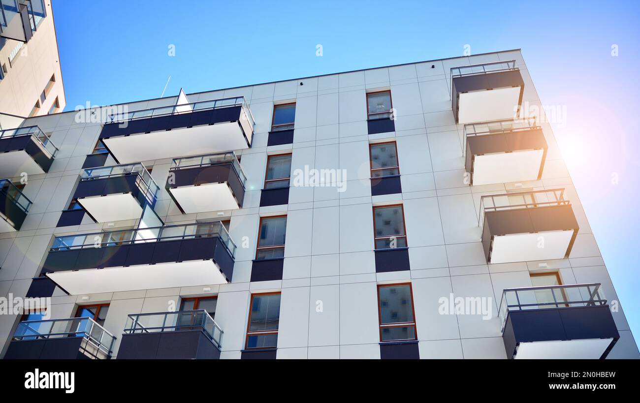 New apartment building with glass balconies. Modern architecture houses by the sea. Large glazing on the facade of the building. Stock Photo