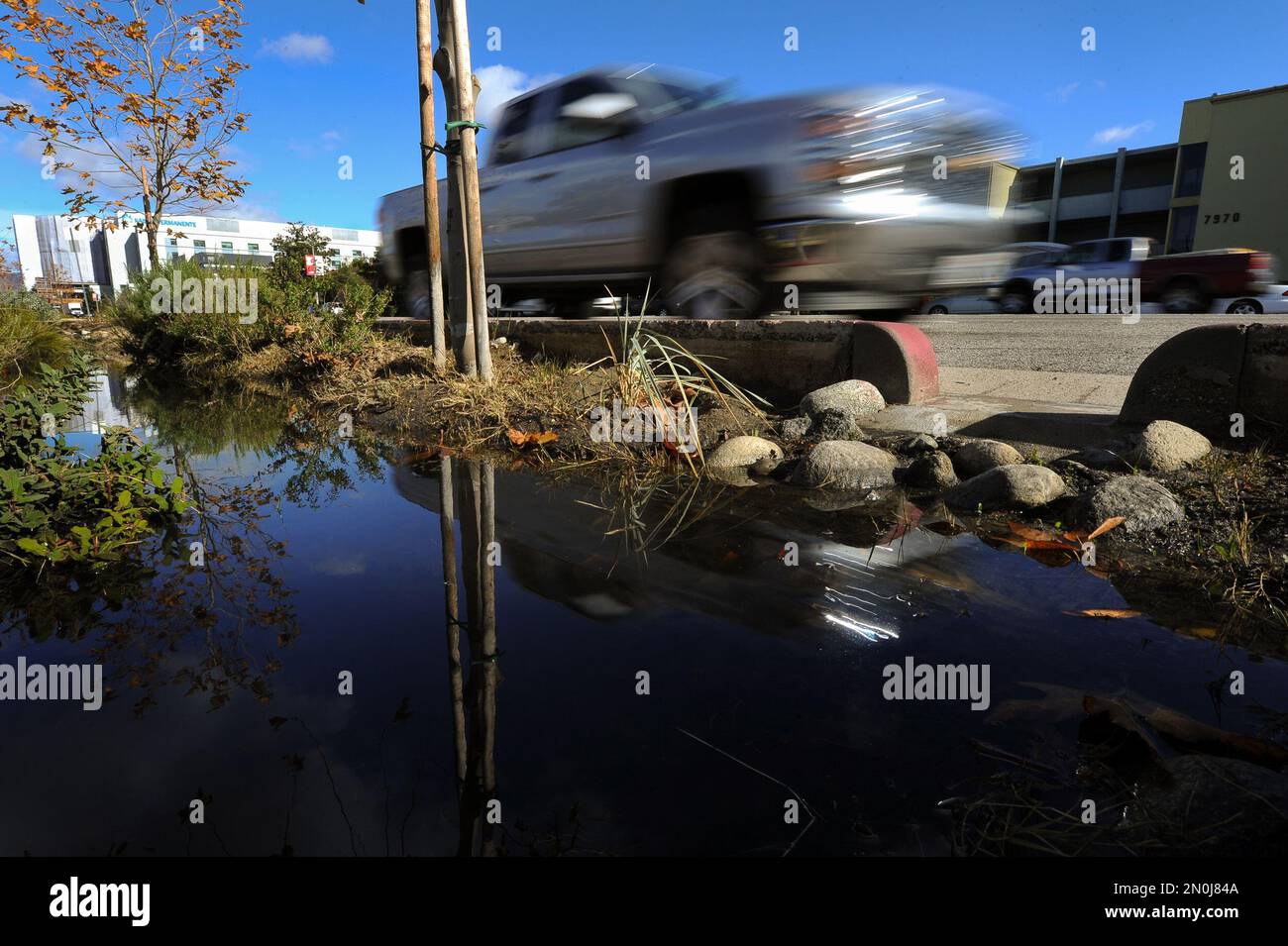 Cars drive on Woodman Avenue in Panorama City, Calif., Thursday, Jan. 7