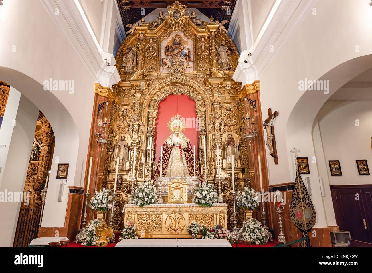 Seville, Spain - January 4, 2023: Main altar of the Virgen de la Esperanza de Triana inside the Capilla de los Marineros (Chapel of the Sailors) in th Stock Photo