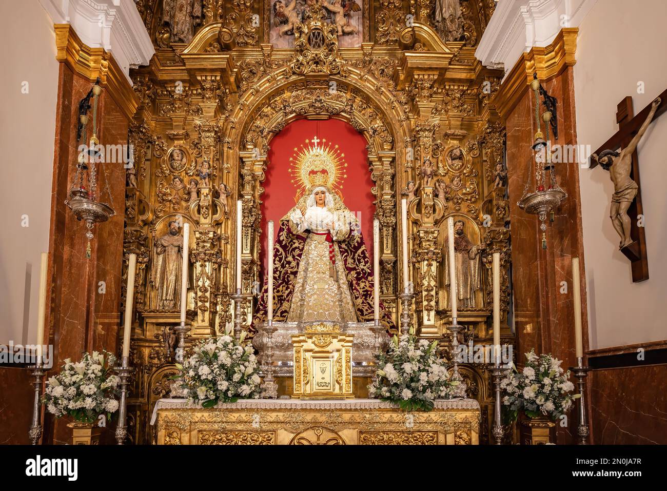 Seville, Spain - January 4, 2023: Main altar of the Virgen de la Esperanza de Triana inside the Capilla de los Marineros (Chapel of the Sailors) in th Stock Photo