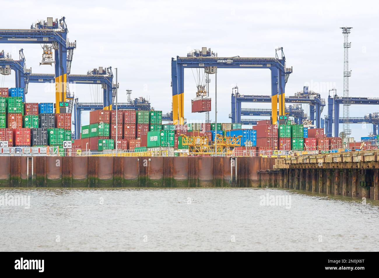 Typical steel shipping containers stacked up on Felixstowe docks, Suffolk, UK Stock Photo