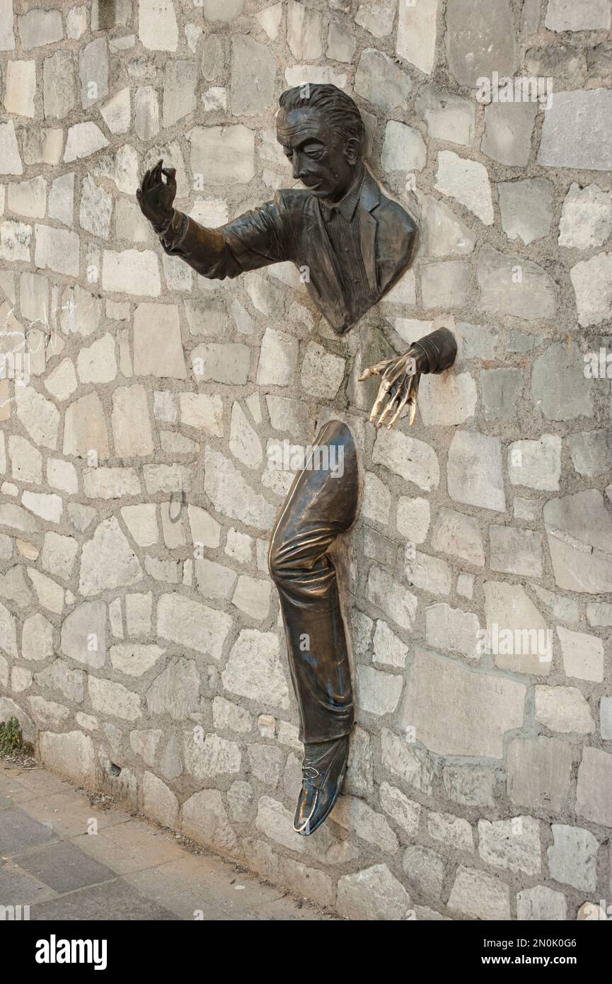 PARIS, FRANCE - MAY 07, 2011:  The Le Passe-Muraille (the man who walks through walls) sculpture by  Jean Marais in Rue Norvins Stock Photo