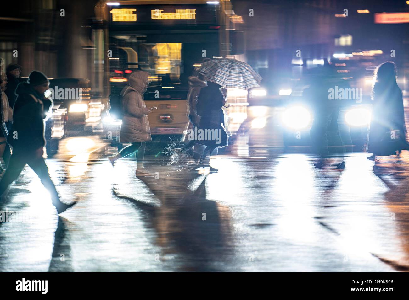 Passers-by at a pedestrian crossing, at the main station, rainy weather, city centre, in the evening, Essen, NRW, Germany, Stock Photo