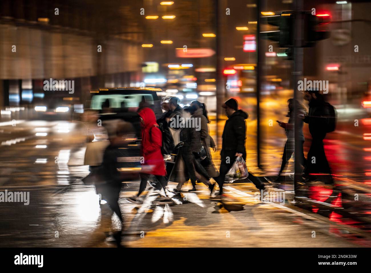 Passers-by at a pedestrian crossing, at the main station, rainy weather, city centre, in the evening, Essen, NRW, Germany, Stock Photo