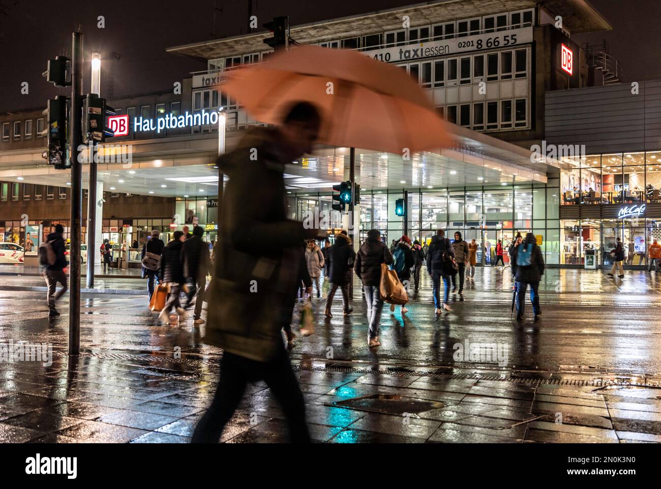 Passers-by at a pedestrian crossing, at the main station, rainy weather, city centre, in the evening, Essen, NRW, Germany, Stock Photo