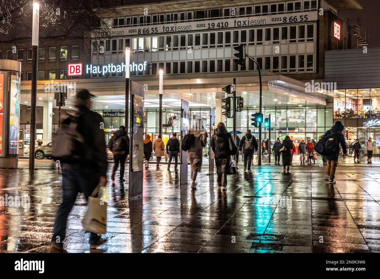 Passers-by at a pedestrian crossing, at the main station, rainy weather, city centre, in the evening, Essen, NRW, Germany, Stock Photo