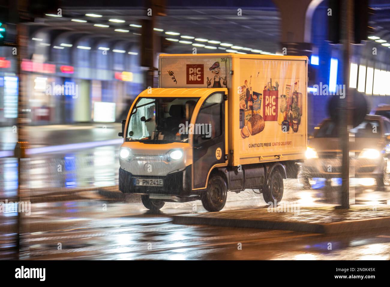 Picnic food delivery service vehicle, rainy weather, city centre