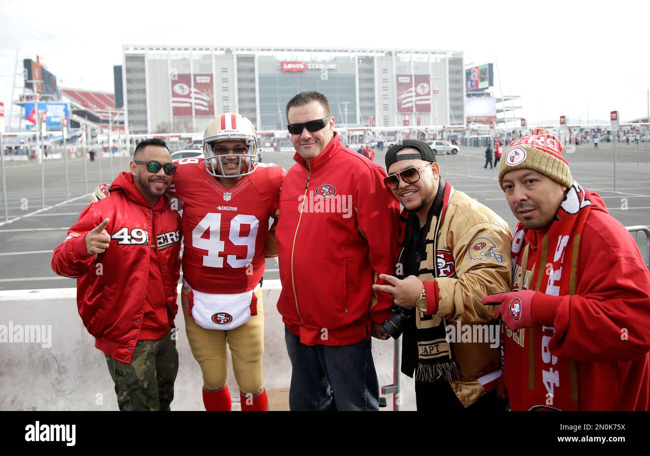 San Francisco 49ers fans pose for photos while tailgating at Levi's