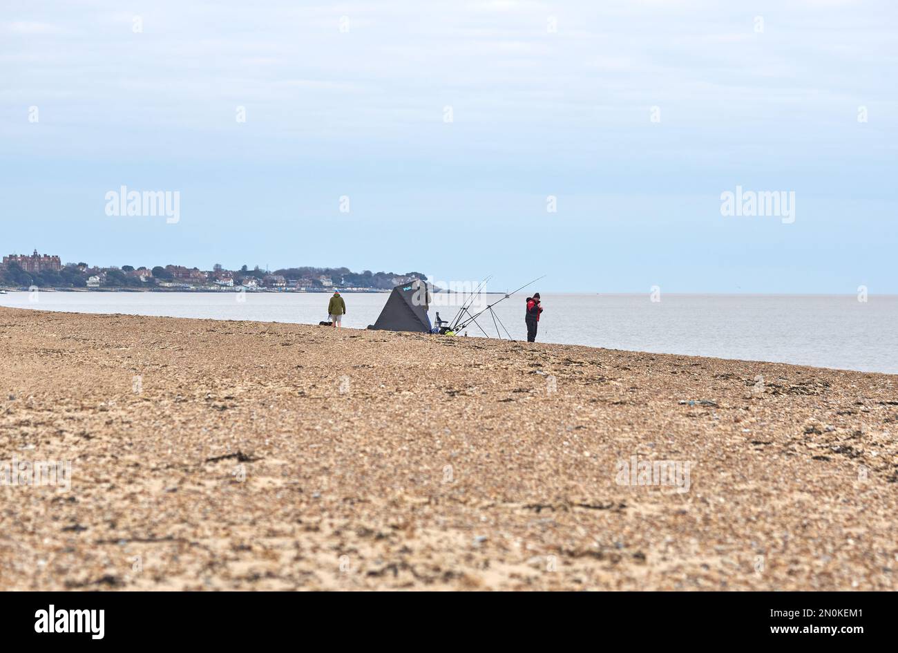 A long exposure of an angler at night with a headlamp fishing on Chesil  beach in Dorset. Other anglers can be seen in the background. The super  blood Stock Photo - Alamy