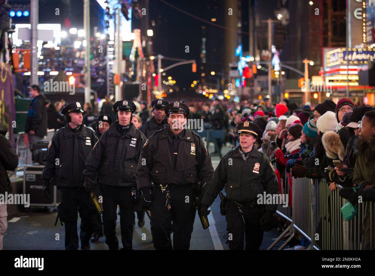 New York police officers patrol behind the barricades during the hours ...