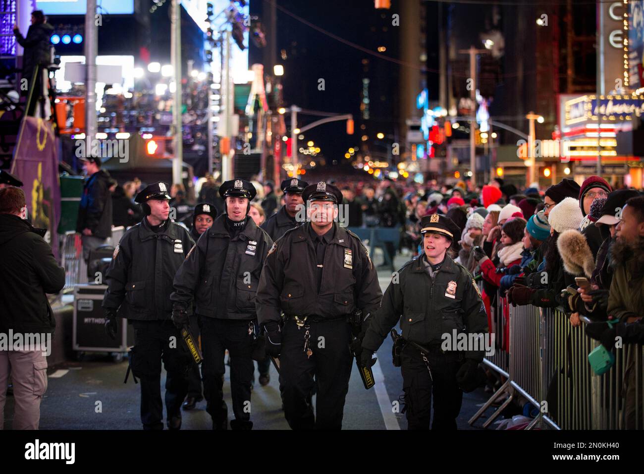 New York police officers patrol behind the barricades during the hours ...